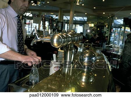 Man cleaning glasses in cafe View Large Photo Image Stock Photo - Man cleaning glasses in cafe. Fotosearch