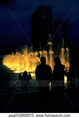 People silhouetted in front of fountain at night View Large Photo Image Stock Image - People silhouetted in front of fountain at night. Fotosearch