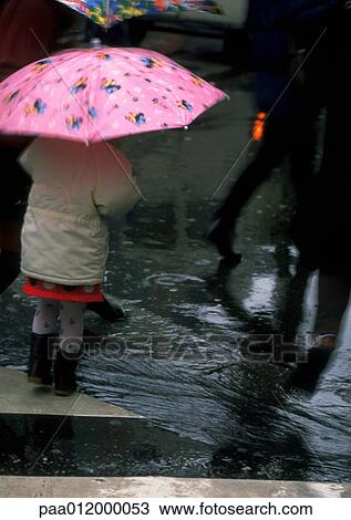 Stock Image - People walking in rain. Fotosearch