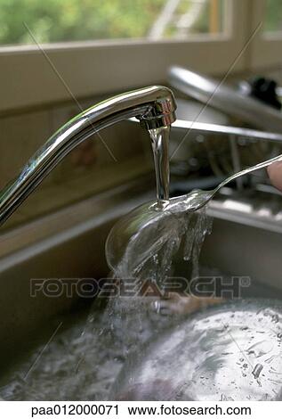 Water pouring from faucet onto spoon View Large Photo Image Stock Image - Water pouring from faucet onto spoon. Fotosearch