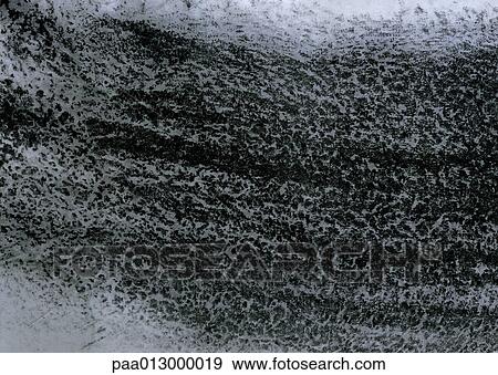 Stock Photo - Black charcoal on texture paper, close-up, full frame. Fotosearch