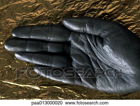 Silver painted hand against gold paper, close-up View Large Photo Image Stock Image - Silver painted hand against gold paper, close-up. Fotosearch