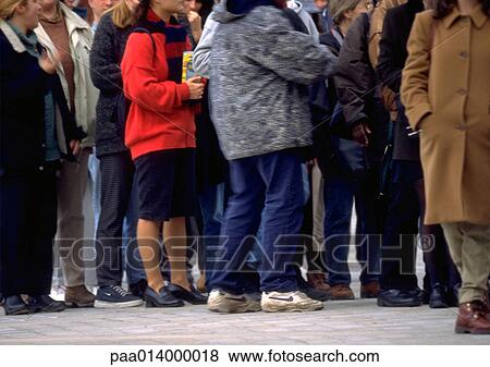 Crowd of people standing in line on sidewalk, neck down View Large Photo Image Stock Photo - Crowd of people standing in line on sidewalk, neck down. Fotosearch