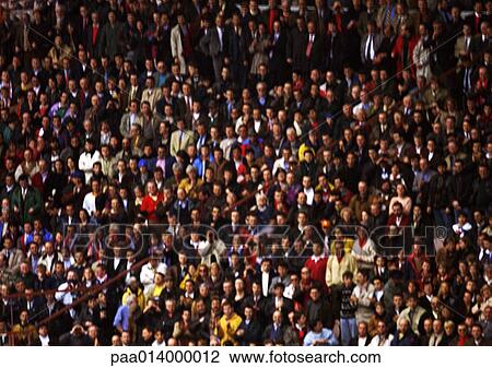 Stock Image - Crowd of spectators, front view, blurred, full frame. Fotosearch