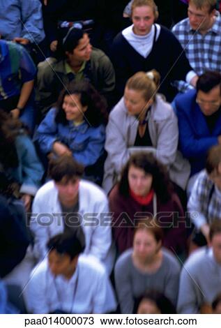 Stock Image - Crowd sitting in bleachers, close up, blurred.. Fotosearch