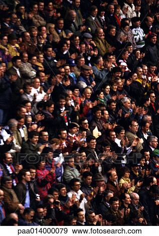 Stock Photo - Crowd sitting in stadium, blurred.. Fotosearch