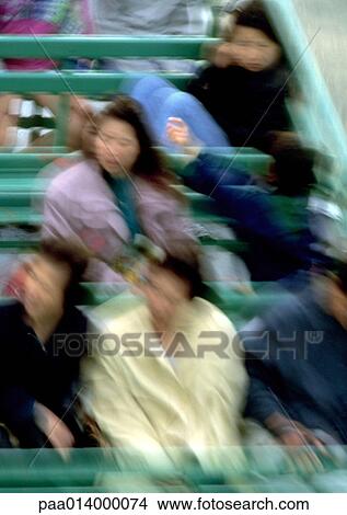 Picture - Group of people sitting in bleachers, motion, blurred.. Fotosearch