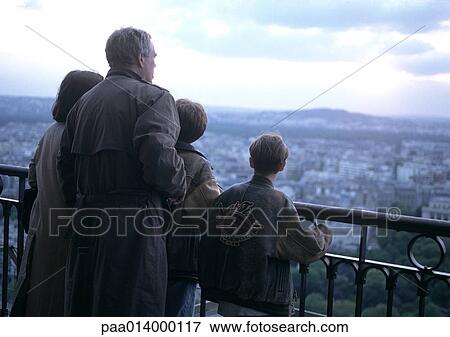 Group of people standing by rail overlooking city View Large Photo Image Stock Photo - Group of people standing by rail overlooking city. Fotosearch