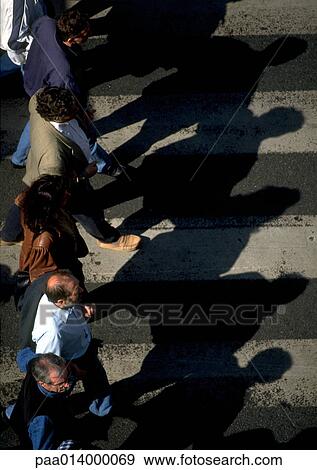 Stock Photo - Group of people standing on crosswalk, high angle view. Fotosearch