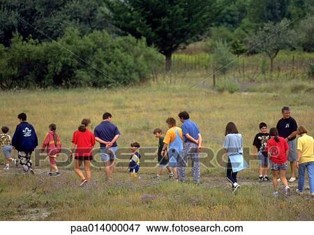 Stock Photo - Group of people walking a trail. Fotosearch