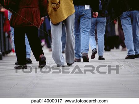 Stock Photo - Lower section of people walking on sidewalk, blurred.. Fotosearch