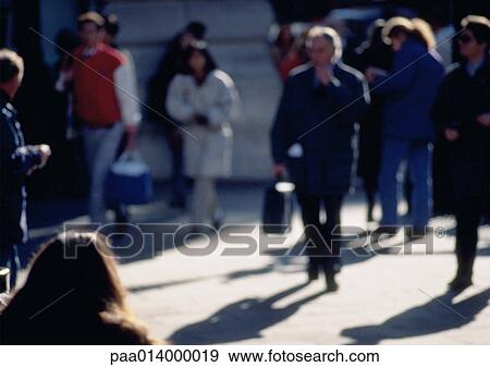 Stock Photo - People walking on sidewalk, blurred.. Fotosearch