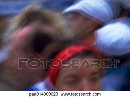 Stock Image - Peoples' heads in a crowd, close up, blurred.. Fotosearch