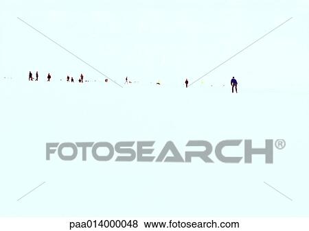 Stock Photo - Silhouette of line of people walking in distance. Fotosearch