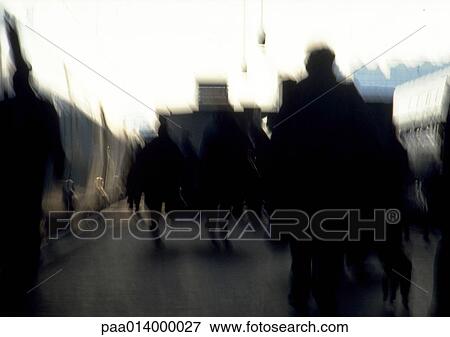 Stock Photo - Silhouette of people walking towards the distance, blurred.. Fotosearch