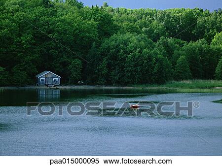 Stock Photography - Finland, cabin at edge of lake. Fotosearch