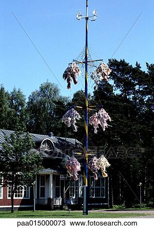 Finland, Maypole in front of red brick building View Large Photo Image Stock Image - Finland, Maypole in front of red brick building. Fotosearch