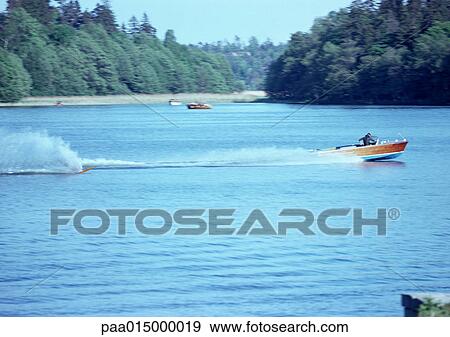 Stock Photo - Finland, motorboats on lake. Fotosearch