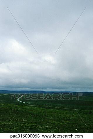 Iceland, road through plain under cloudy sky View Large Photo Image Stock Image - Iceland, road through plain under cloudy sky. Fotosearch