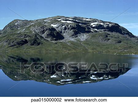 Norway, mossy, snow-patched rocky land reflected in sea View Large Photo Image Stock Image - Norway, mossy, snow-patched rocky land reflected in sea. Fotosearch