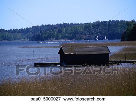 Stock Photo - Scandinavia, boathouse next to lake. Fotosearch