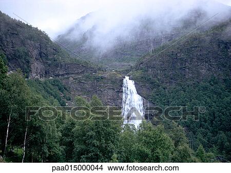 Waterfall in mountains with mist View Large Photo Image Picture - Waterfall in mountains with mist. Fotosearch