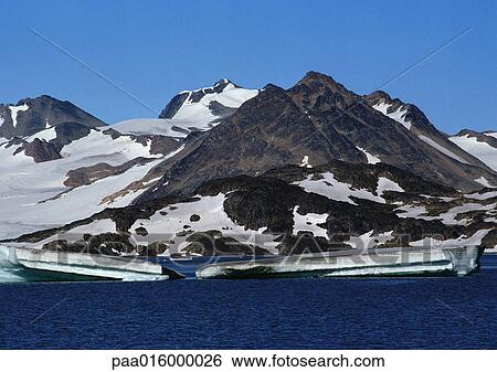 Greenland, snow-patched mountains next to sea with icebergs View Large Photo Image Stock Photograph - Greenland, snow-patched mountains next to sea with icebergs. Fotosearch