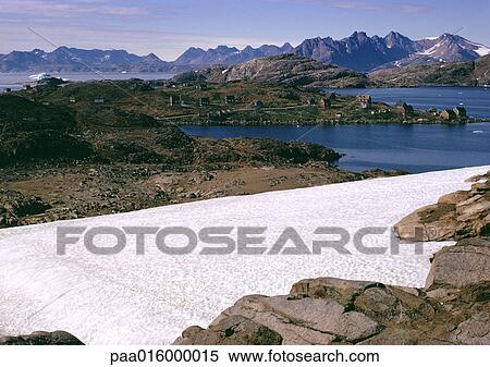 Stock Photography - Greenland, village with mountain range in background. Fotosearch
