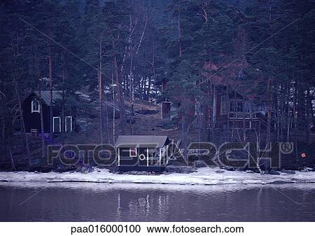Sweden, cabins in woods near water's edge View Large Photo Image Stock Image - Sweden, cabins in woods near water's edge. Fotosearch