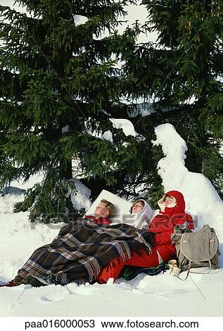 Stock Image - Sweden, hikers sleeping near fir tree. Fotosearch