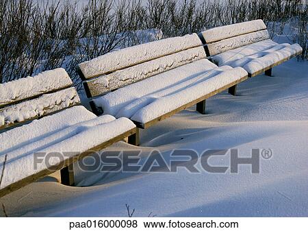Stock Photo - Sweden, park benches covered with snow. Fotosearch