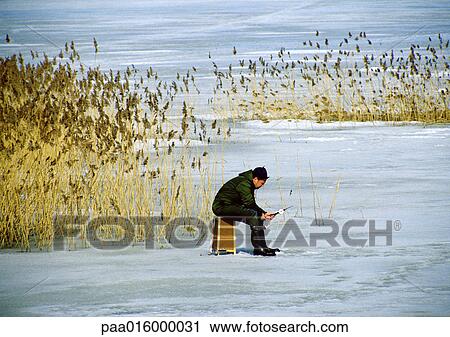 Sweden, person fishing on frozen water View Large Photo Image Stock Image - Sweden, person fishing on frozen water. Fotosearch