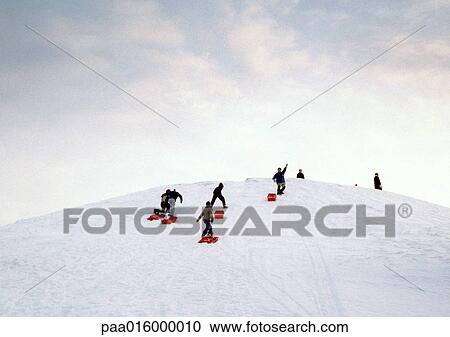 Stock Image - Sweden, sledders walking up hill. Fotosearch