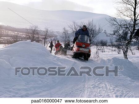 Stock Photo - Sweden, snowmobiles on snowy landscape. Fotosearch