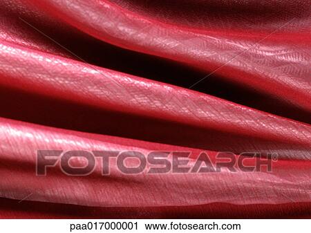 Stock Image - Folds in pink fabric, close-up, full frame. Fotosearch