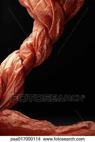 Twisted salmon-colored fabric against black background View Large Photo Image Picture - Twisted salmon-colored fabric against black background. Fotosearch