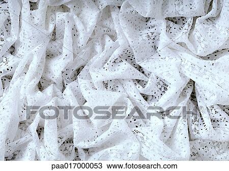 Stock Image - White eyelet, close-up, full frame. Fotosearch