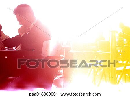 Businessman sitting at table, red-yellow filter. View Large Photo Image Stock Image - Businessman sitting at table, red-yellow filter.. Fotosearch
