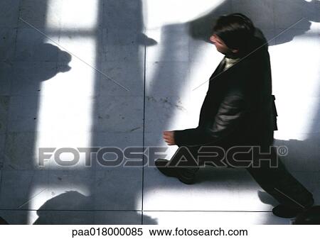 Stock Photography - Businessman walking, view from above.. Fotosearch