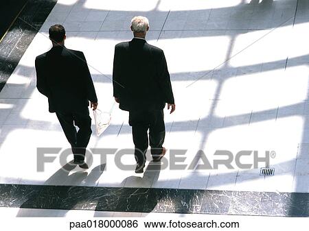 Businessmen walking together, view from above. View Large Photo Image Stock Photograph - Businessmen walking together, view from above.. Fotosearch