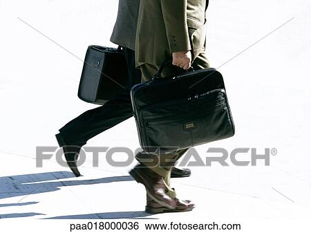 Businessmen walking with briefcases, view from waist down. View Large Photo Image Stock Photograph - Businessmen walking with briefcases, view from waist down.. Fotosearch