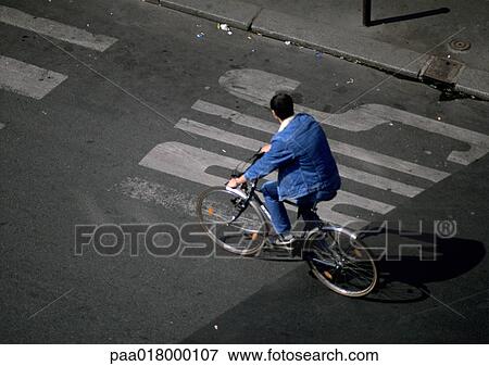 Stock Photo - Man riding bike, view from above.. Fotosearch