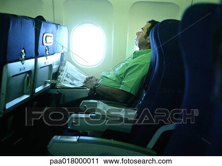 Man sleeping on plane. View Large Photo Image Stock Image - Man sleeping on plane.. Fotosearch