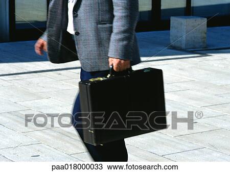 Man walking with briefcase, mid section, blurred motion View Large Photo Image Stock Image - Man walking with briefcase, mid section, blurred motion. Fotosearch