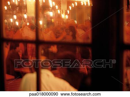People at restaurant, view from outside looking in. View Large Photo Image Stock Image - People at restaurant, view from outside looking in.. Fotosearch