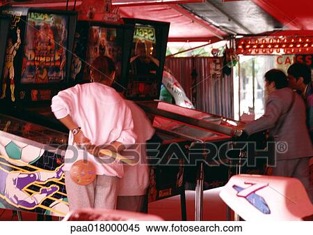People playing pinball at arcade. View Large Photo Image Stock Photography - People playing pinball at arcade.. Fotosearch