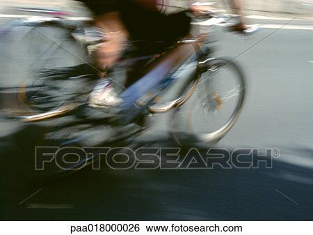Person riding bike, lower section, blurred. View Large Photo Image Stock Photograph - Person riding bike, lower section, blurred.. Fotosearch