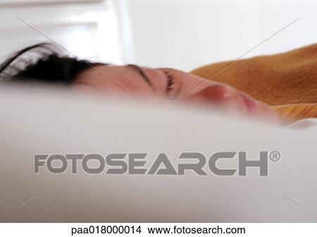 Picture - Woman sleeping in bed.. Fotosearch