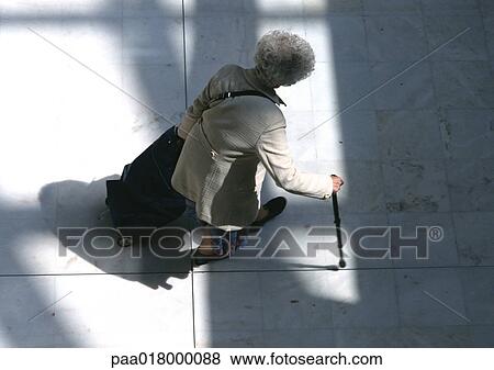 Woman walking with cane, view from above. View Large Photo Image Stock Photo - Woman walking with cane, view from above.. Fotosearch