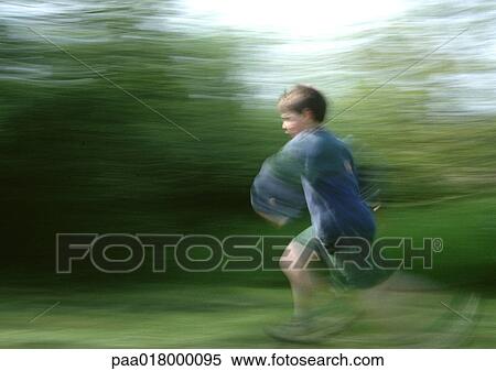 Stock Photography - Young boy running, full length, blurred.. Fotosearch